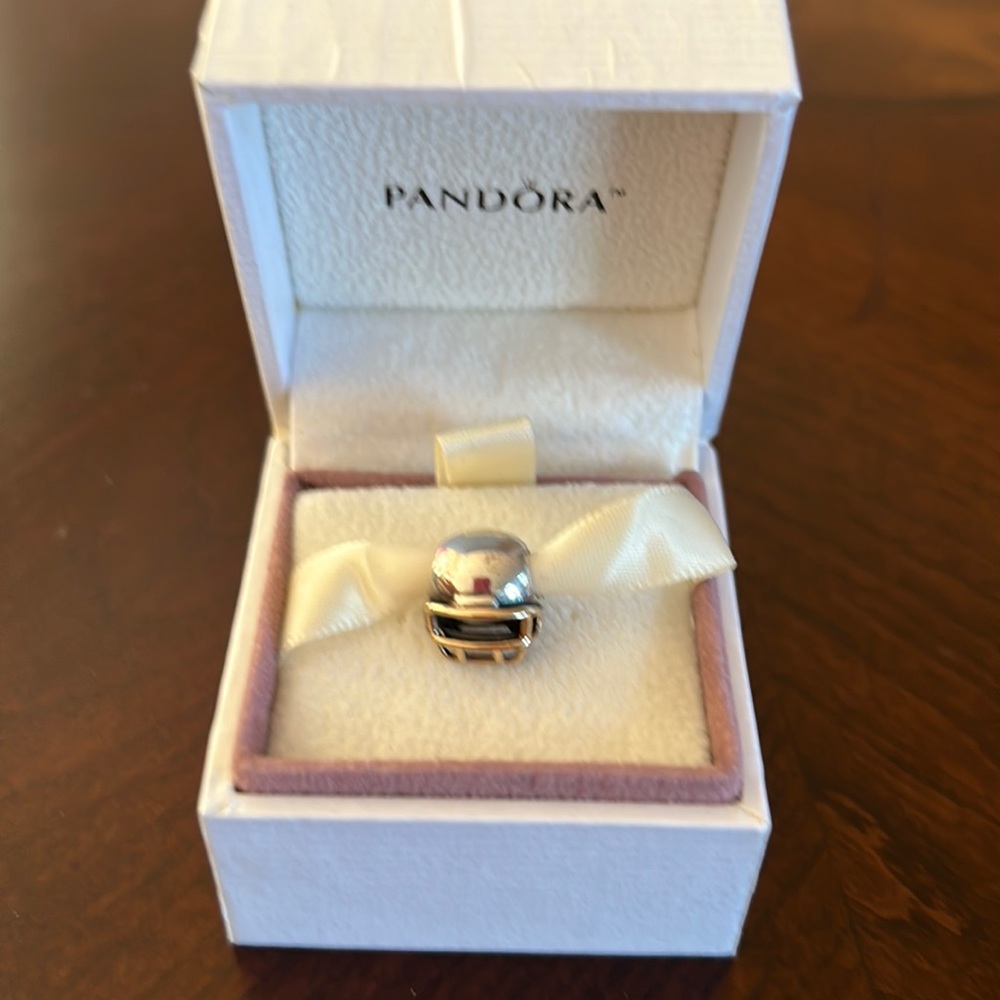 Authentic Pandora two toned silver and gold football helmet.